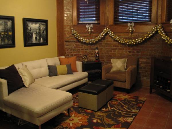 Beautiful Historic Rental With Roof Deck | Living Room With Exposed Brick