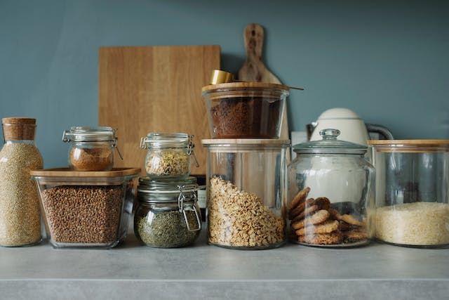 designing a walkin pantry feature image of jars on a shelf with a cutting board behind them