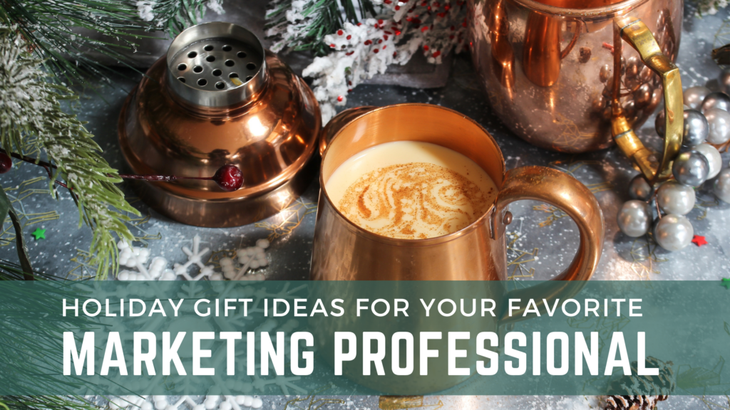 Holiday decorations and a copper mug of cocoa with an overlaid banner that reads holiday gift ideas for your favorite marketing professional